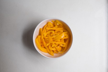 top view of sliced yellow bell pepper on white counter top.の写真素材
