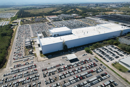 Aerial view of new cars stock at factory parking crowded lot. Automotive industry. Logistics...