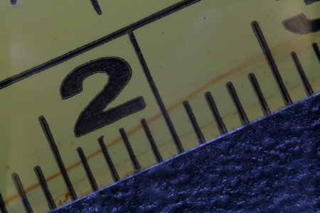 Close-up of a metal ruler with a number two on it