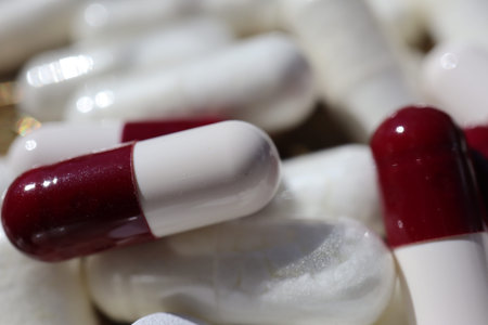 Close up of white and red pills with shallow depth of field.