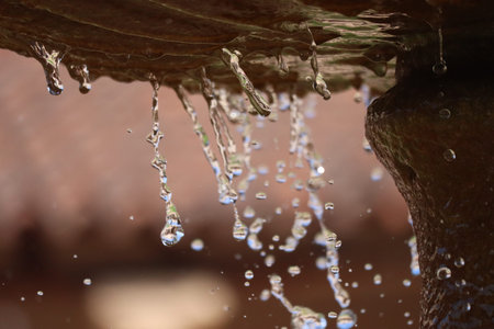Water dropping from fountain in park.