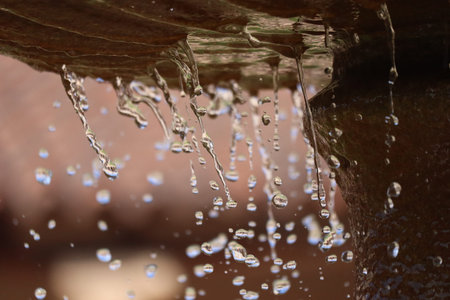 Water dropping from fountain in park.
