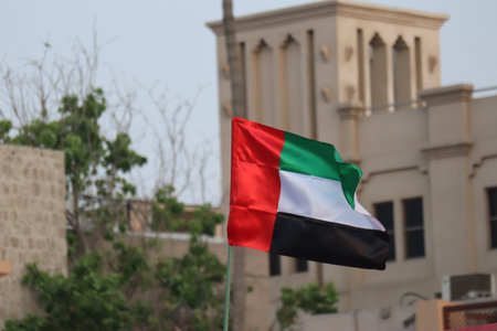 Flag of United Arab Emirates against blue skyの写真素材