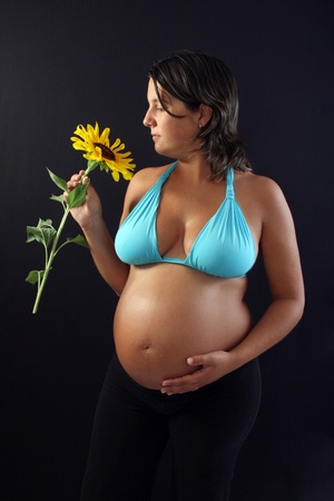 pregnant woman with beautiful belly and sunflowerの写真素材