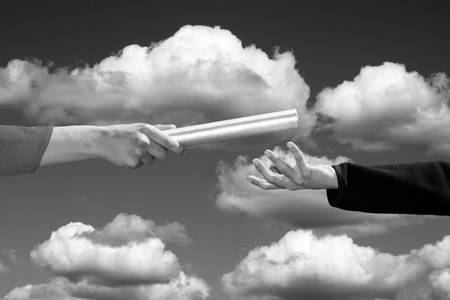 hands passing the baton, business and sports themeの写真素材