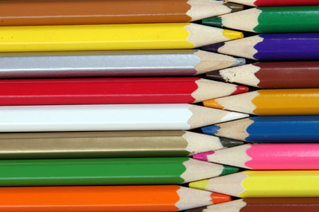 Assortment of coloured pencils with shadow on white/black background