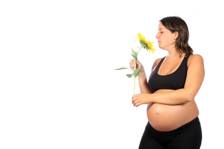 pregnant woman with beautiful belly and sunflowerの写真素材