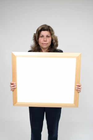Young woman holding blank boardの写真素材