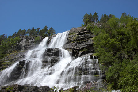 Big waterfall in a fjord it norway in springの写真素材