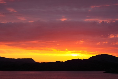 sunset view from a boat off the coast of norwayの写真素材