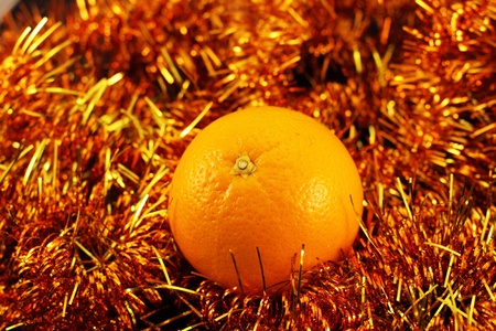 orange close up on a background of twinkling garlandsの写真素材