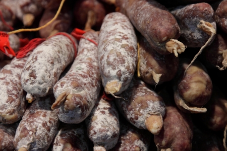 different varieties of sausage salami on a stallの写真素材