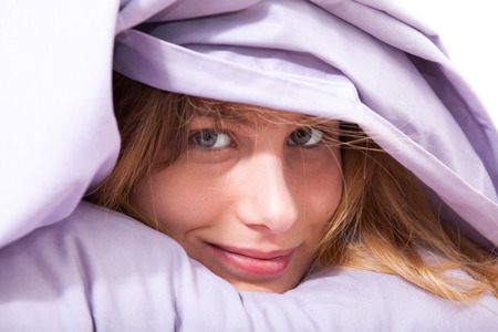 smiling woman in bedの写真素材