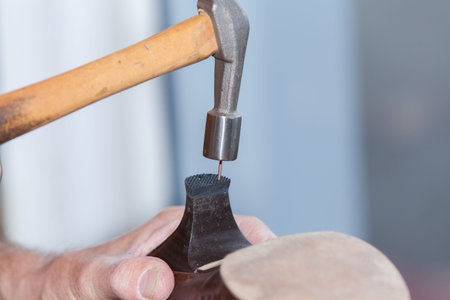 the shoemaker repairs a shoe