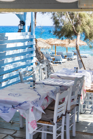 restaurant terrace in front of the beach in kamari on the island of santoriniの写真素材