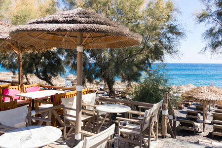 Restaurant terrace in front of the beach in kamari on the island of Santoriniの写真素材