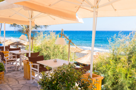 restaurant terrace in front of the beach in kamari on the island of santoriniの写真素材