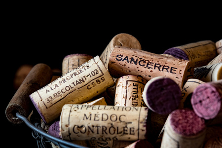 old cork stoppers of French wines in a wire basketのeditorial素材