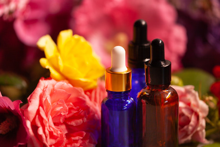 flowers and bottles of essential oils for aromatherapyの写真素材