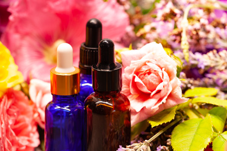 flowers and bottles of essential oils for aromatherapyの写真素材