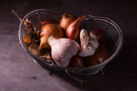 poster of an old basket with onion garlic tomatoes to decorate the kitchenの写真素材