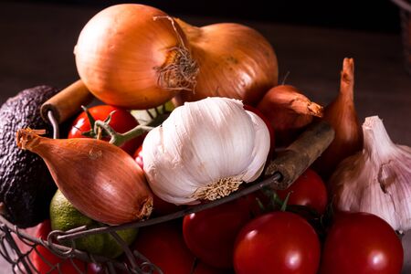 poster of an old basket with onion garlic tomatoes to decorate the kitchenの写真素材