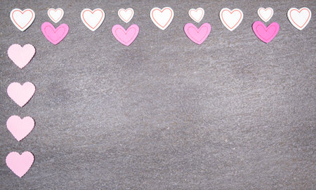 gray granite background with pink and white hearts for valentines day. Valentine's day and love concept.の写真素材