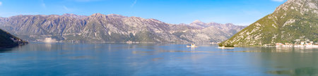 Panoramic view of Kotor bay surrounded by mountains with the city of Perast and the island of Our...