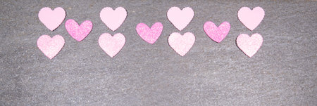 gray granite background with pink and white hearts for valentines day. Valentine's day and love concept.の写真素材