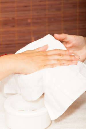 Preparing a woman's hands for a manicureの写真素材