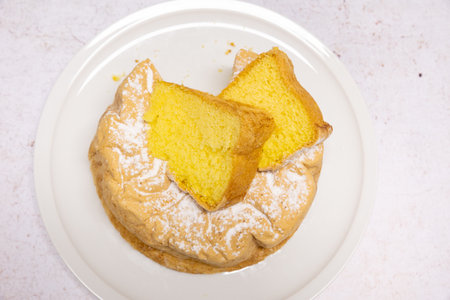 Homemade Savoie cake on a pretty white porcelain dish.の写真素材