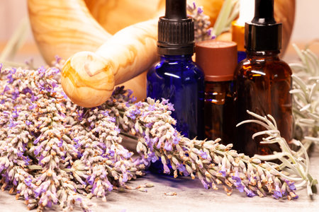 lavender mortar and pestle and bottles of essential oils for aromatherapyの写真素材