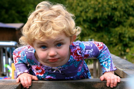 Cute little girl surrounded by greeneryの写真素材