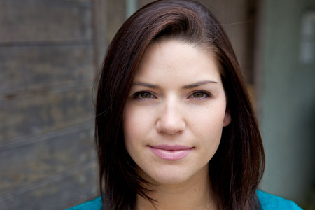 A Beautiful Brunette with fresh skin looking at camera