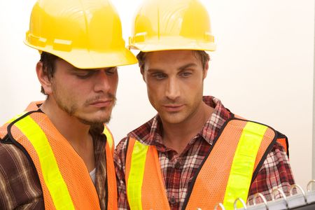 Two Construction Workers at the job working togetherの写真素材