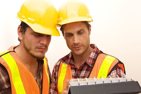 Two Construction Workers at the job working togetherの写真素材