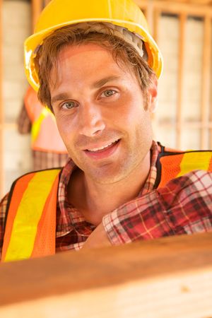 A closeup of a construction worker with a hard hatの写真素材