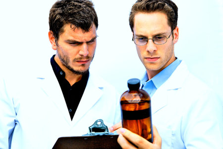 Two Scientists working together one with a blue shirtの写真素材