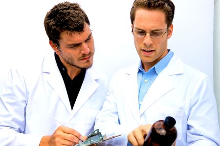 Two Scientists working together one with a blue shirtの写真素材
