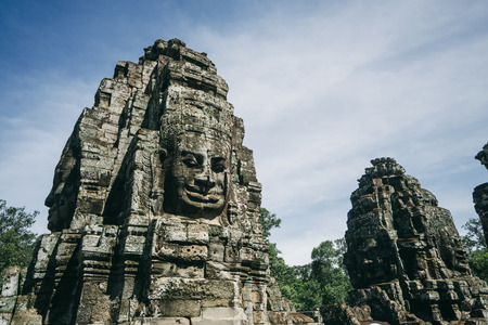 A giant stone statue from the ancient temples of Angkor which is one of the most important archaeological sites in the world.の写真素材