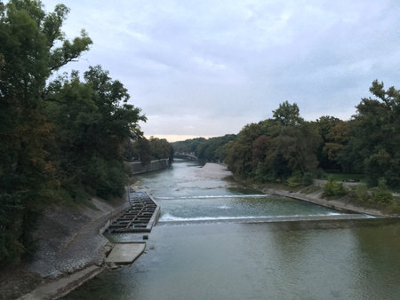 Panoramic view of the Isar River under a cloudy blue skyの写真素材
