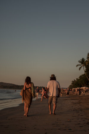 Standing on Beach During Romantic Sunset with Ocean Waves and Sandの写真素材