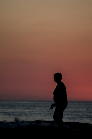 Silhouette of people at sunset on tamarindo, Costa Ricaの写真素材