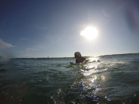 Tamarindo, Costa Rica - People surfing off the beachの写真素材
