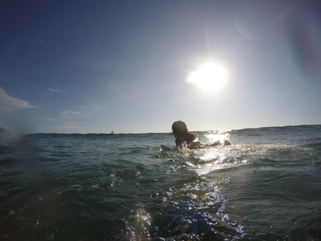 Tamarindo, Costa Rica - People surfing off the beachの写真素材