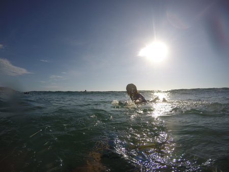 Tamarindo, Costa Rica - People surfing off the beachの写真素材