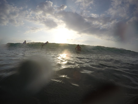 Tamarindo, Costa Rica - People surfing off the beach - travel to central americaの写真素材