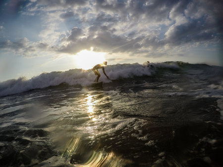 Tamarindo, Costa Rica - People surfing off the beachの写真素材
