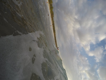 Tamarindo, Costa Rica - People surfing off the beachの写真素材