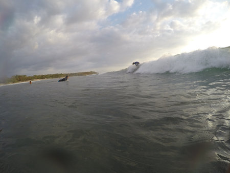 Tamarindo, Costa Rica - People surfing off the beach - travel to Central Americaの写真素材